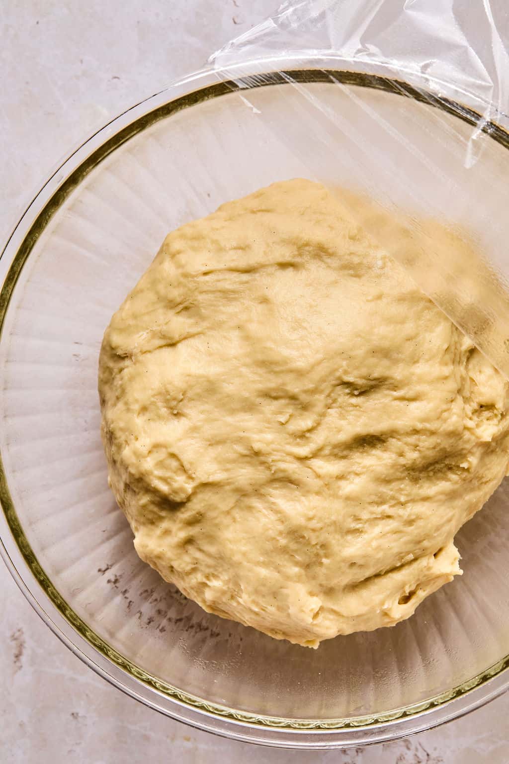 cinnamon roll dough in a bowl after rising the first time.
