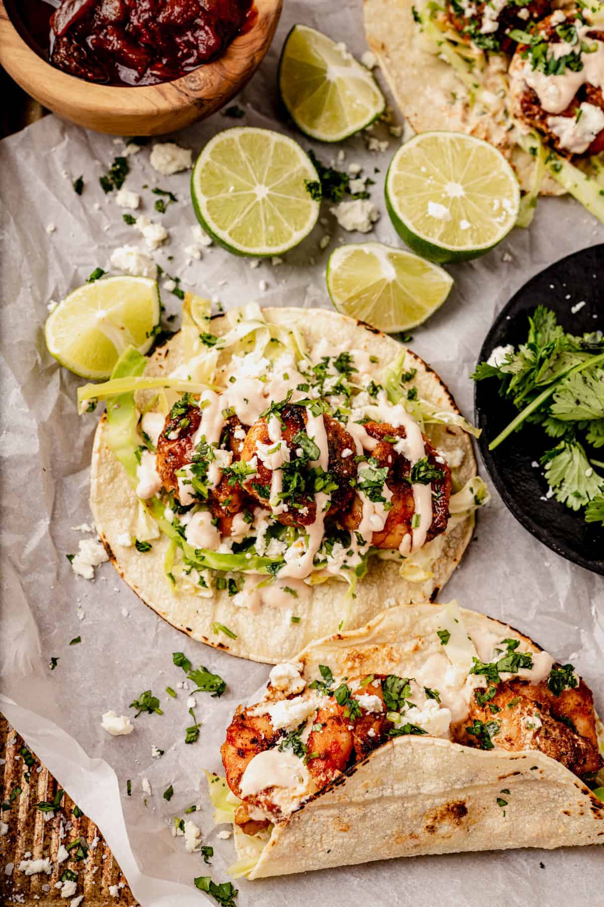 a blackened shrimp taco with cilantro lime slaw and chipotle crema drizzled on top.