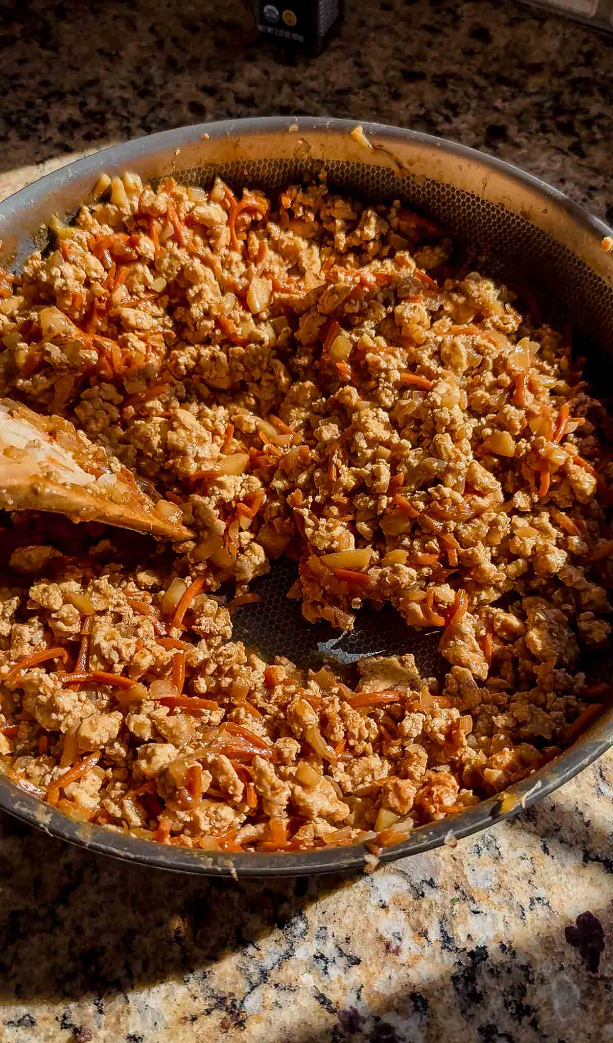 ground chicken lettuce wrap filling in a skillet on the counter.
