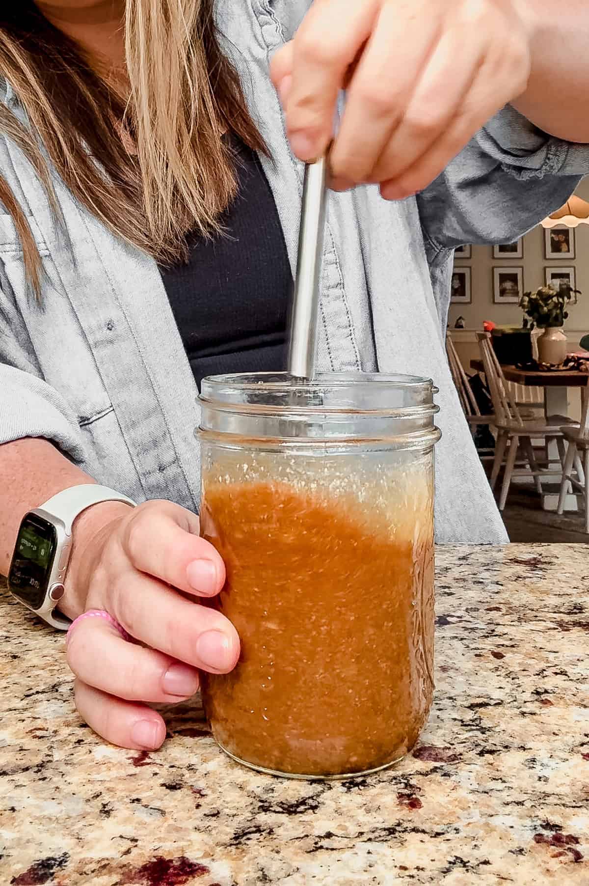 whisking dressing for mandarin orange chicken salad in a mason jar.