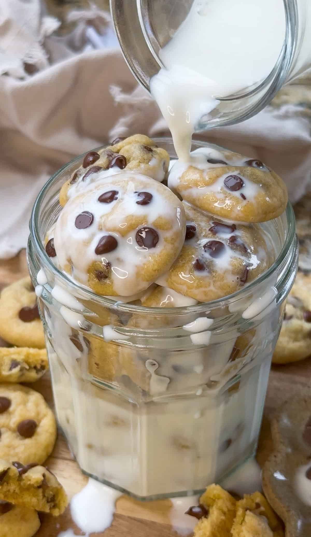 pouring milk over a jar of mini chocolate chip cookies.