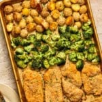 Parmesan crusted chicken sheet pan dinner with crispy golden potatoes, broccoli, and breaded chicken cutlets, all baked and seasoned, on a beige countertop.